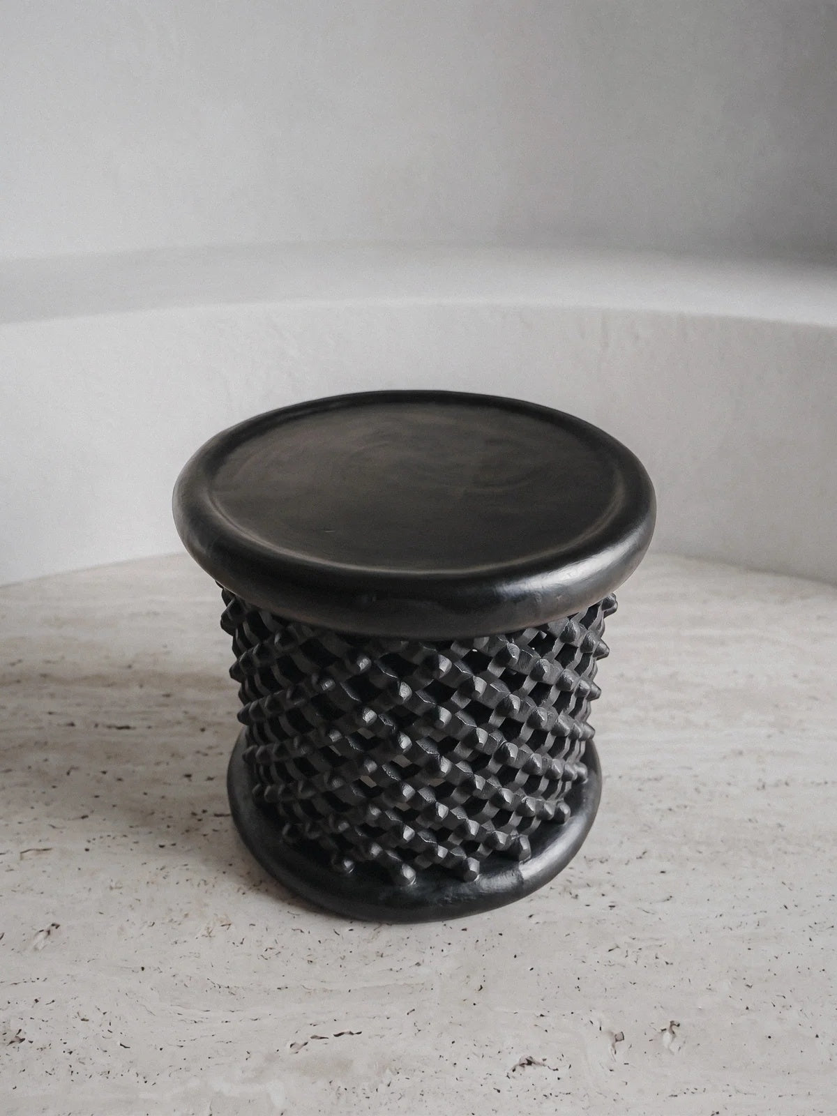 Top view of the Casarin sculptural monolithic stool in ebonized timber